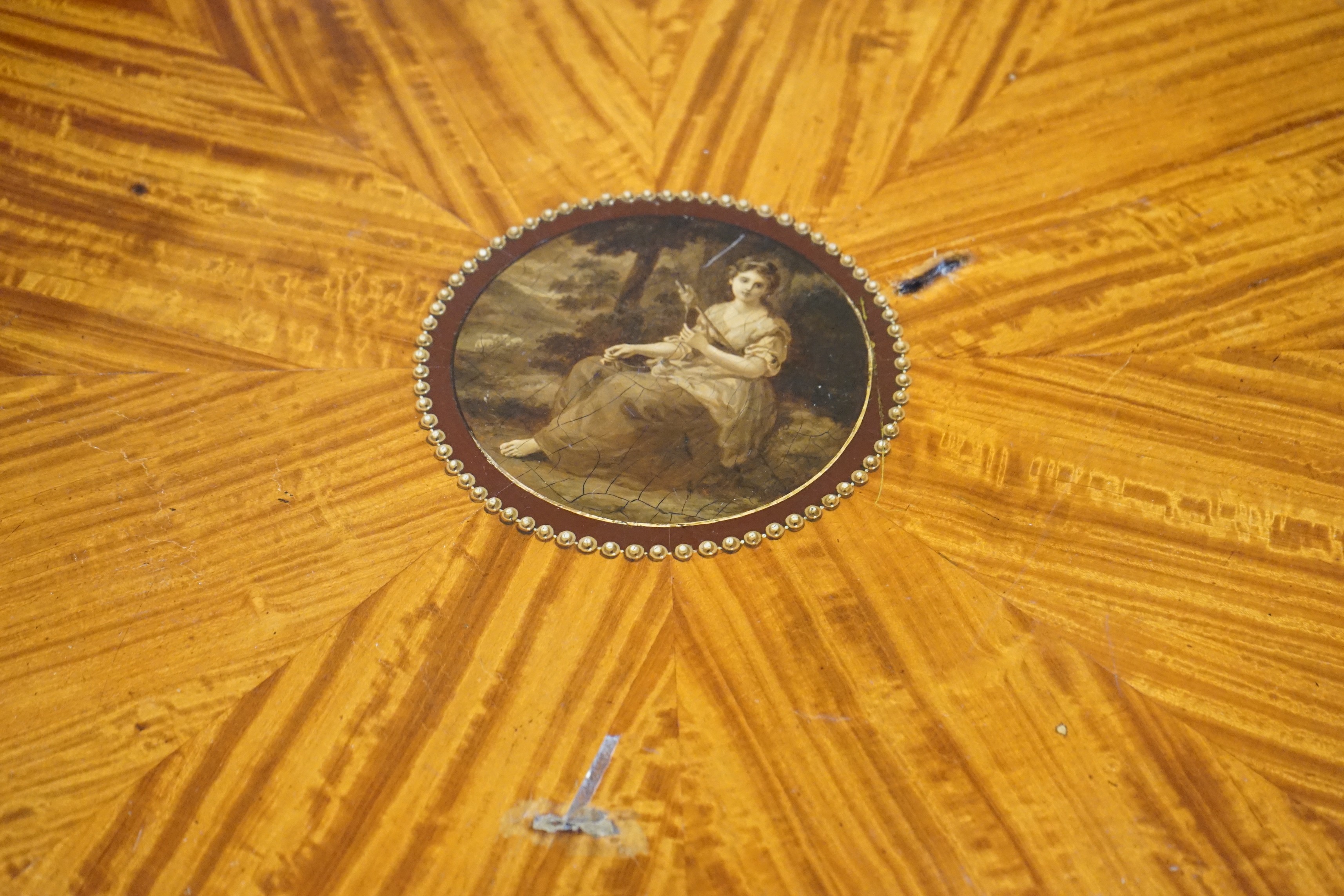 An Edwardian Sheraton revival circular painted satinwood centre table, diameter 76cm, height 77cm